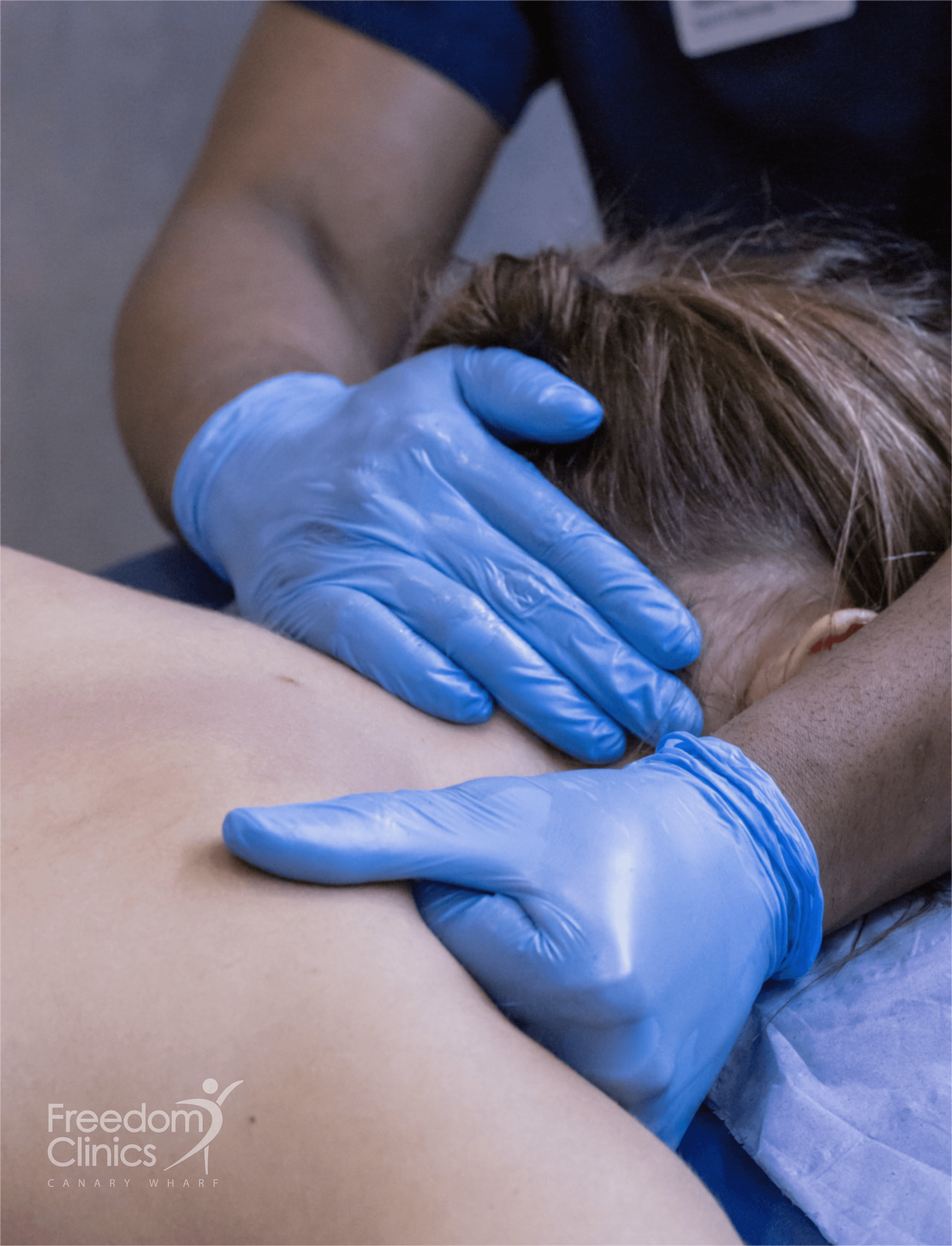 A Freedom Clinics physiotherapist treating a client in Canary Wharf